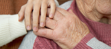 Image of an older woman being cared for